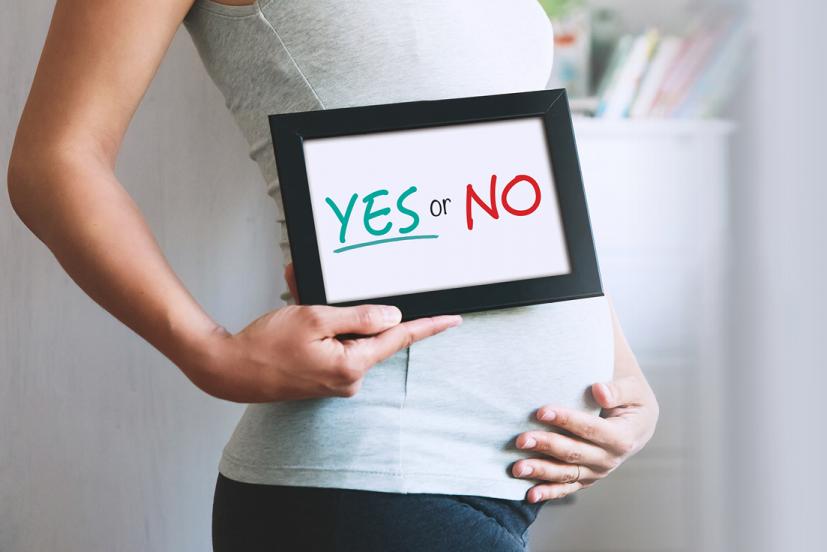 pregnant woman with yes or no sign