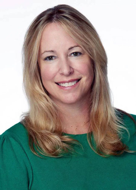 Meredith Simpson head shot blonde woman in green blouse