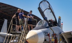 Open cockpit jet fighter with visiting family