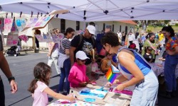 Pride craft table with kids at Bay Area Discovery Museum