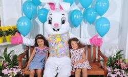 Easter Bunny with two little girls and balloons in background