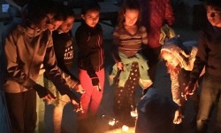 Kids sitting around campfire at night