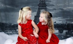 Little girls in dresses for holiday tea with Eiffel tower in background