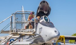 Open cockpit jet fighter with visiting family