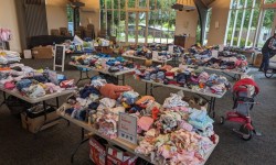Give and Take kids free clothing event tables with kids' clothes