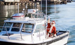 Santa on boat sailing into Nick's Cove on Tomales Bay