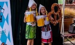 Girls posing with fake beer and pretzels Oktoberfest