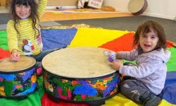 Kids enjoying indoor play at Wee Yogis in San Anselmo, featuring Montessori climbing structures, sensory toys, and creative activities.