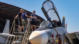 Open cockpit jet fighter with visiting family