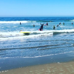 Beach view with people in water