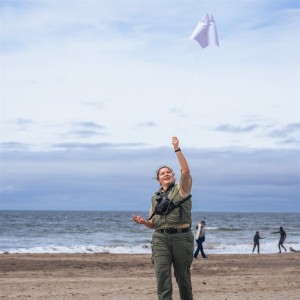Ranger flying a kite at the beach