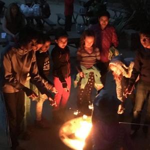 Kids around campfire