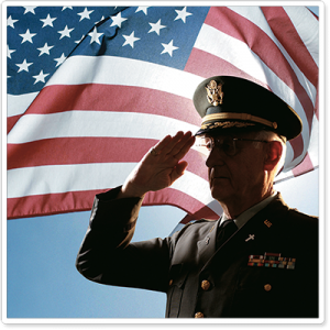 Military officer saluting the flag veterans day