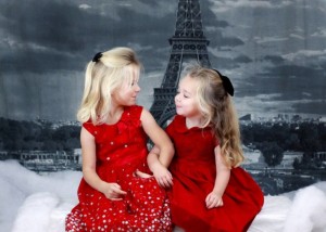 Little girls in dresses for holiday tea with Eiffel tower in background