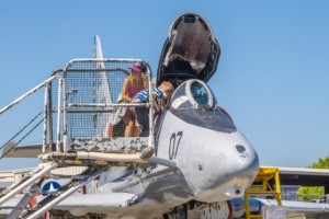 Open cockpit jet fighter with visiting family