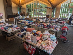 Give and Take kids free clothing event tables with kids' clothes