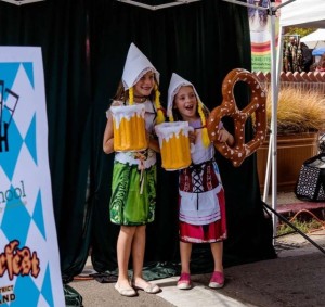 Girls posing with fake beer and pretzels Oktoberfest