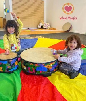 Kids enjoying indoor play at Wee Yogis in San Anselmo, featuring Montessori climbing structures, sensory toys, and creative activities.