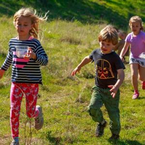 Junior ranger kids running in field