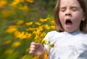 girl with allergies sneezing