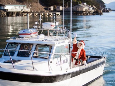 Santa on boat sailing into Nick's Cove on Tomales Bay