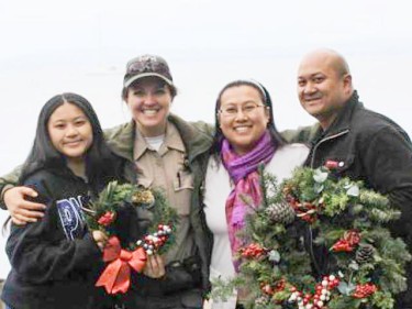 family and ranger with wreaths