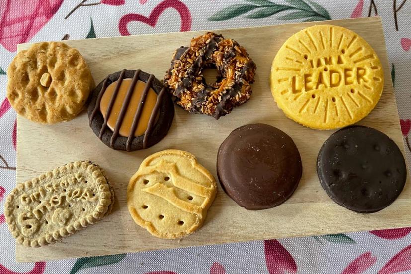 Girl Scout cookies arranged on a wooden tray