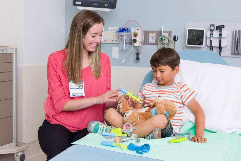 Nurse with young boy in hospital