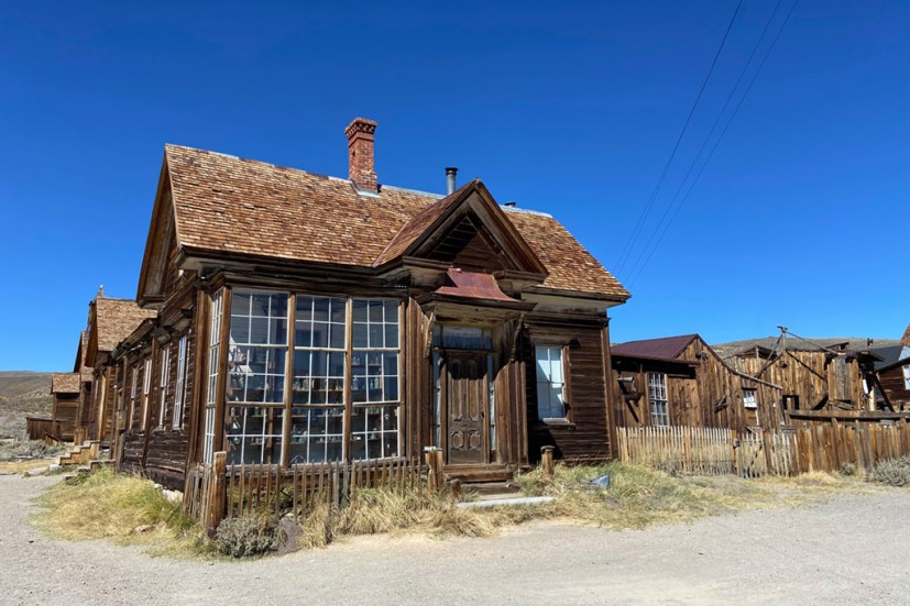 Building in Bodie with large glass window arrayed with antique bottles