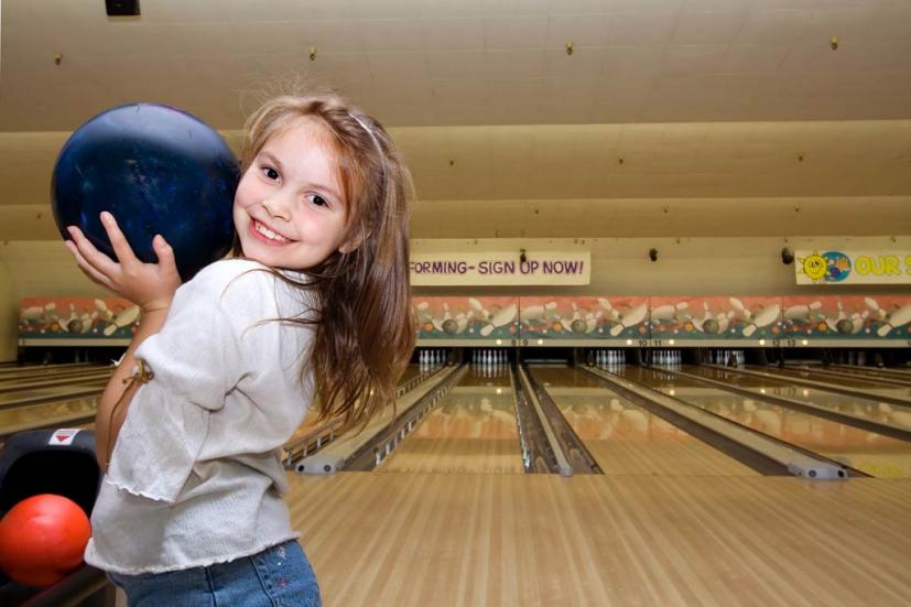 Child bowling at birthday party