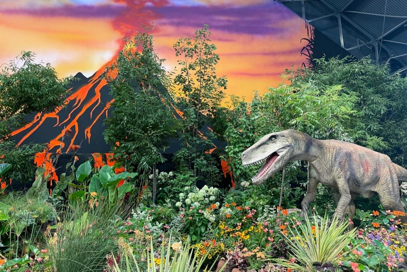 Flower show with dinosaur and volcano backdrop