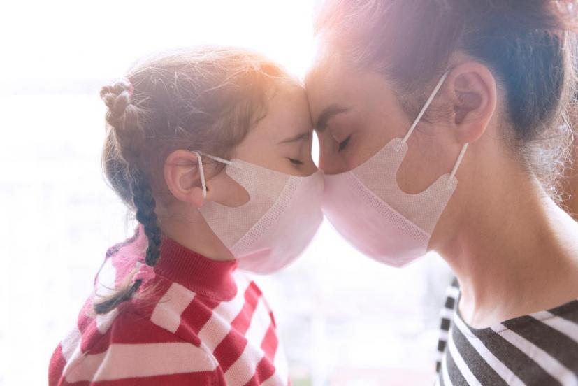 Mother and daughter wearing masks