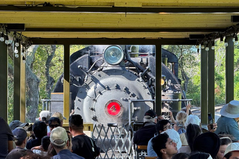 View from open-air car of steam locomotive pushing it Niles Canyon Railway