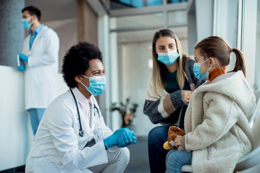 Doctor with mom and young girl