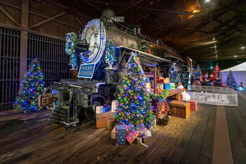 Steam locomotive with Christmas Trees and Polar Express sign at California State Railroad Museum