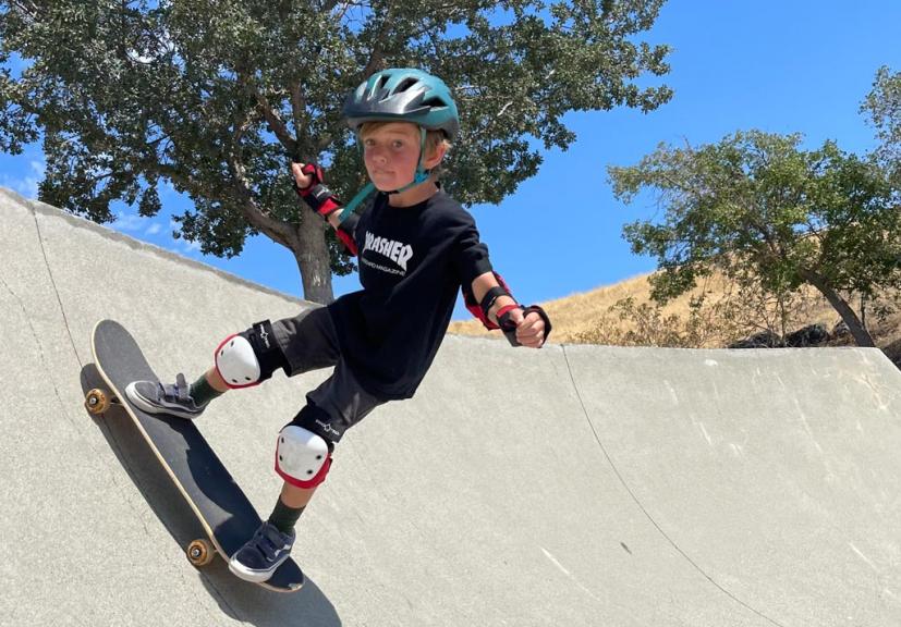 Young boy skateboarding at skate park