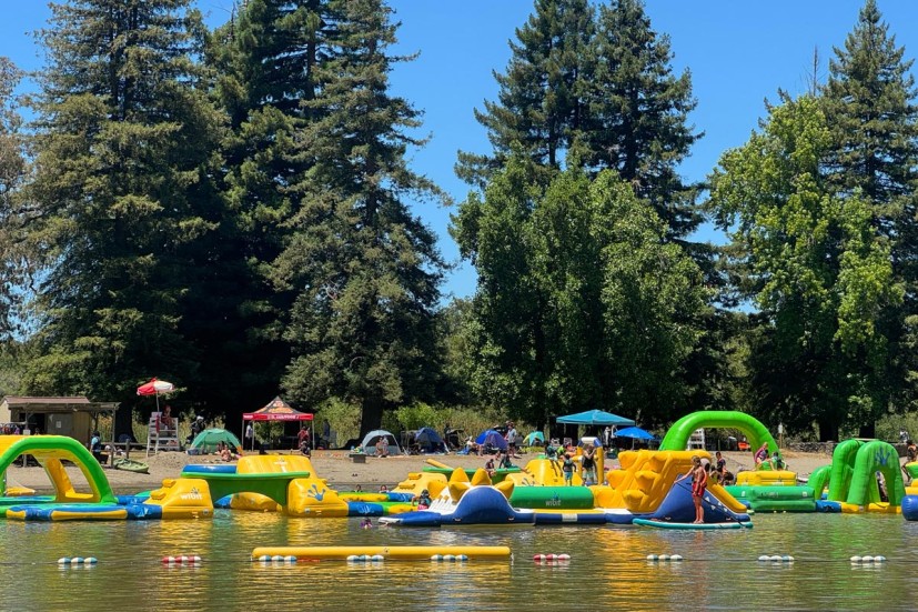 Spring Lake Water Park inflatables on water with trees in background