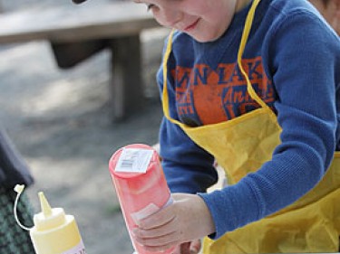 Child painting with smock on