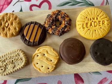 Girl Scout cookies arranged on a wooden tray