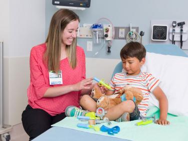 Nurse with young boy in hospital