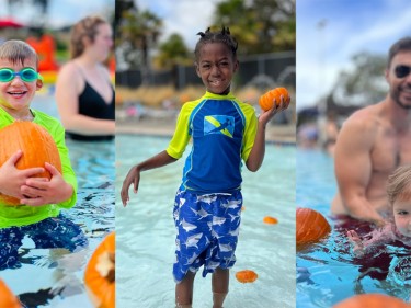 Families and kids in pool with pumpkins