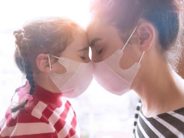 Mother and daughter wearing masks