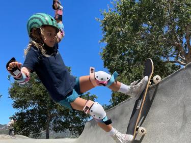 Young girl skateboarding at skate park